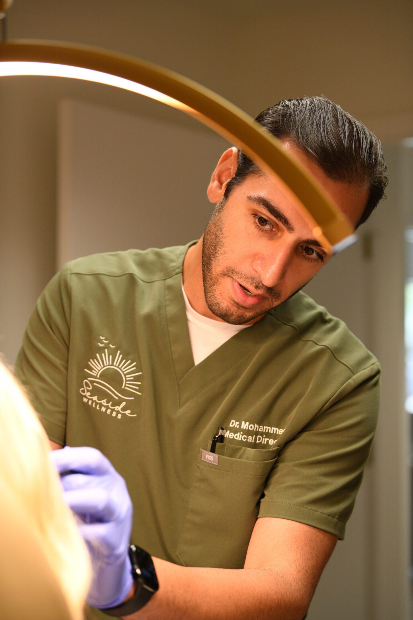 Dentist examining patient's teeth under lamp