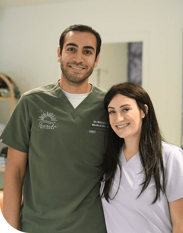 Two smiling healthcare professionals in medical scrubs